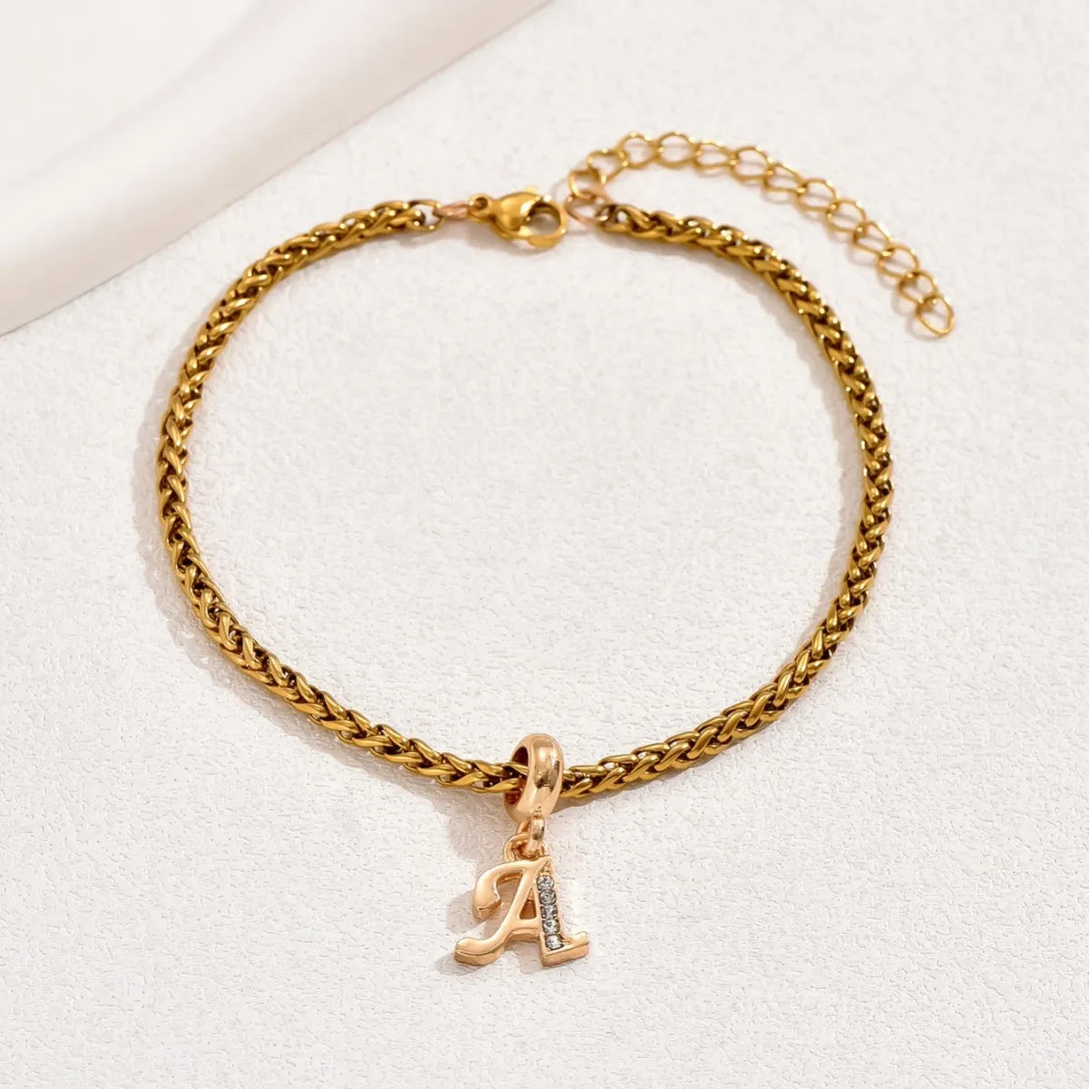 Gold initial charm bracelet with letter A pendant and adjustable chain