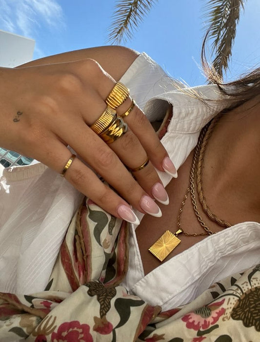 Savaé Design layered gold necklaces and rings